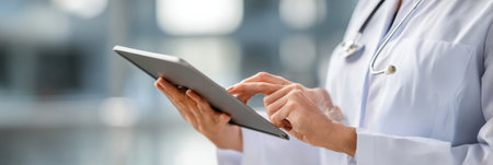 A veterinarian records examination details on a tablet device while attending to a patient in a contemporary clinic environment during daylight hours.の素材