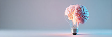 A brain shaped like a lightbulb filament symbolizes the blend of creativity and intelligence in soft pastels.の素材