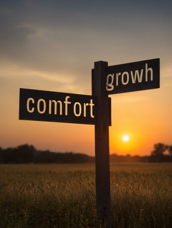 A stunning sunrise illuminates a crossroads marked by signs labeled comfort and growth, symbolizing pivotal life decisions amidst a serene landscape.の素材