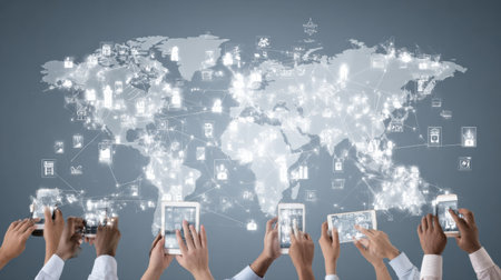 Hands holding various digital devices display a global map with interconnected icons, symbolizing the exchange of knowledge and ideas worldwide.の素材