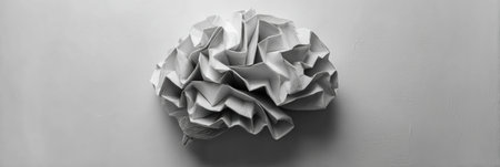 A unique piece of art features a folded paper brain gradually transforming into expansive pathways, highlighting creativity and artistic expression in design.の素材