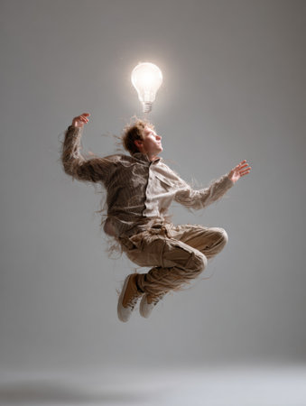 A young person hovers mid-air with a bright light bulb emitting creative energy, surrounded by a neutral backdrop emphasizing the power of imagination.の素材