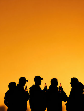 A group of friends shares a moment, holding beer bottles against a stunning gradient sunset, silhouetted against an evening sky, creating a relaxing atmosphere.の素材