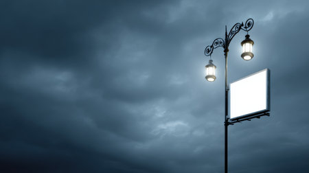 A streetlamp stands tall with an illuminated advertising display, casting light against the dark, cloudy night sky in an urban environment.の素材