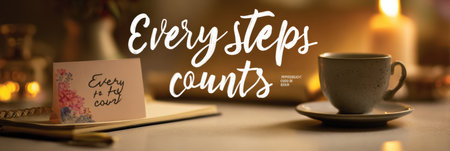 A serene evening with soft lighting highlights a table featuring a motivational quote, an open journal, and a warm cup of tea.の素材