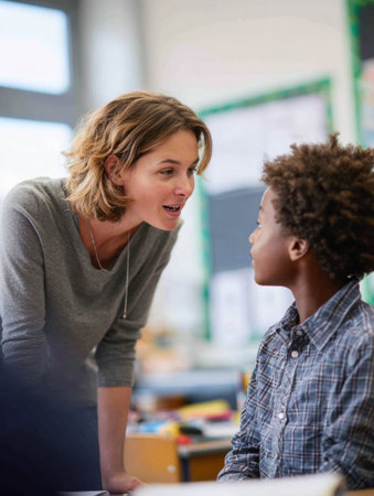 Teacher shows enthusiasm and encouragement to a young student with ADHD for a unique and innovative solution to a problem in class.の素材