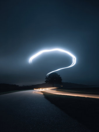 A stunning light trail forms a curved silhouette resembling a brain against a dark night sky, illuminating a winding road below.の素材