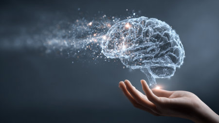 A translucent AI brain floats over an outstretched hand, illustrating the intersection of technology and human intellect against a softly blurred background.の素材