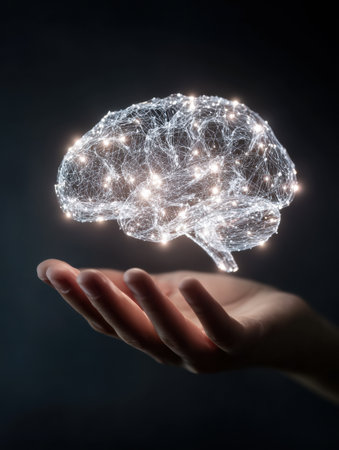 A hand is holding a glowing brain icon that represents intelligence and creativity, illuminated against a dark surface, highlighting its ethereal essence.の素材