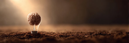 A light bulb designed as a brain grows from dark soil in a warm and open environment, symbolizing creativity, innovation, and intellectual developmentの素材