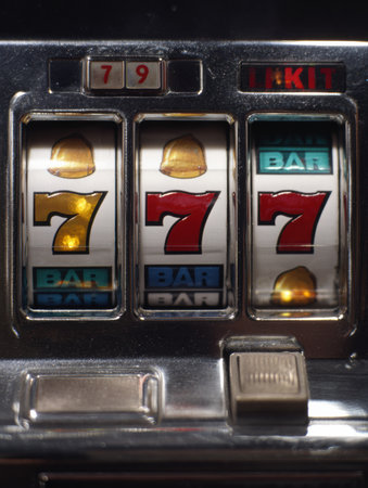 Close-up view of a slot machine featuring a jackpot alignment with vibrant symbols, capturing the excitement of a potential win in a casino setting.の素材