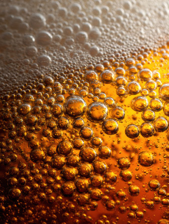Close-up of beer bubbles reveals intricate textures and vibrant colors, transitioning from rich amber to a clear top, highlighting carbonation.の素材
