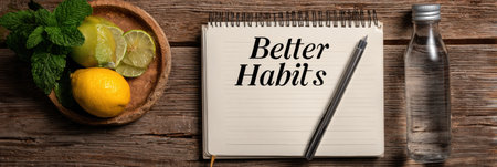 A notebook displaying better habits sits beside fresh fruit and a water bottle, with space available for more ideas, set against a wooden background.の素材