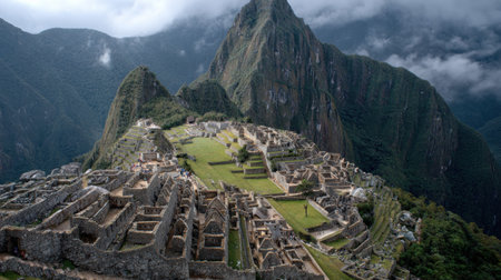 Visitors discover the historical site of Machu Picchu, marveling at its architecture and breathtaking views while clouds gather over the mountains.の素材