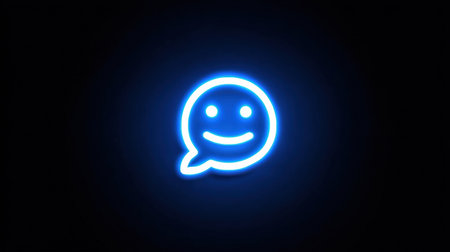 Bright neon blue smiley chat symbol shines on dark surface, illustrating friendly interaction and digital communication themes in modern technology.の素材