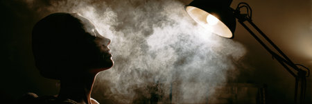 Client relaxes under a steam facial machine, surrounded by cozy ambient lighting, enhancing the calming experience of the skincare ritual.の素材