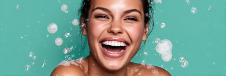 Woman laughing with delight as bubbly cleanser is applied during her cosmetic treatment in a bright and inviting environment.の素材