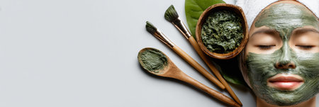 A gentle application of a seaweed mask on the cheek creates a soothing spa experience, complemented by natural tools and a serene backdrop.の素材