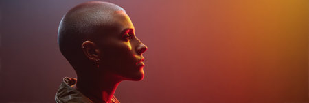 Bright gradient light highlights the profile of a person with a buzz cut against an empty backdrop, creating a striking visual effect in the atmosphere.の素材