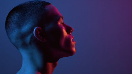 A person with a buzz cut is captured in profile against a gradient light background, emphasizing defined facial features and creating a striking visual effect.の素材