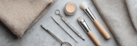 Aesthetic beauty products and small surgical tools are neatly displayed on a soft cloth, creating a clean, minimalistic setup for cosmetic procedures.の素材