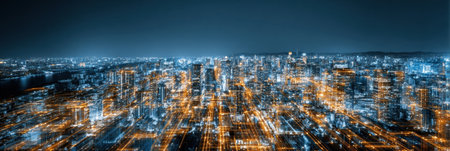 Overlooking a bustling city skyline at night, bright lights illuminate the modern buildings, capturing the essence of urban life and activity.の素材