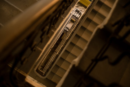 Staircase features intricate railings and layers of steps, highlighting architectural details and shadows cast by natural light in a historic setting.の写真素材