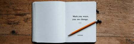 An open notebook lies on a wooden table with a pencil beside it displaying the phrase Wark you ware you ew change, inviting reflection or creativity.の素材