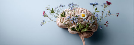 A brain adorned with vibrant flowers represents the connection between thought and nature, highlighting creativity and personal growth in a tranquil setting.の素材