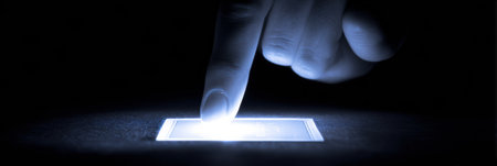 A glowing digital scratch card is activated by a finger swipe, revealing a section of the card with virtual rewards underneath.の素材