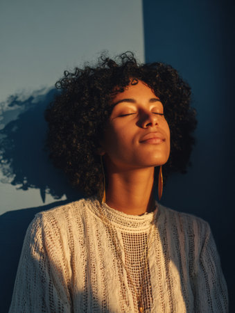 A person engages in calming breathing techniques for stress relief, enjoying the warm morning light while surrounded by peaceful indoor ambiance.の素材