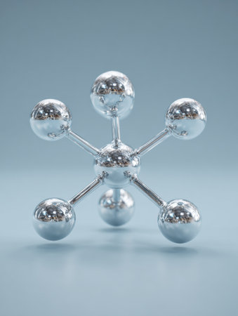 A shiny molecular model crafted from metal is displayed against a soft blue background, illustrating chemical bonds and molecular structures.の素材