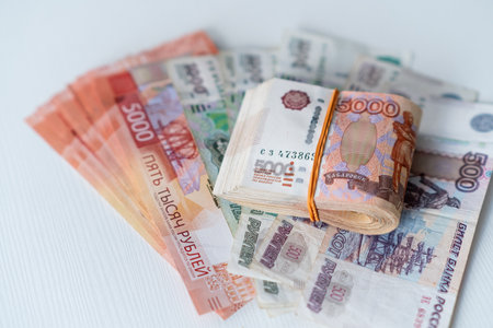 Stacks of Russian rubles are arranged neatly, showing a variety of banknotes in differing...