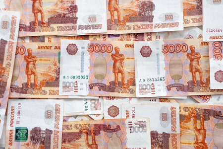 A variety of Russian ruble banknotes are spread out, showing intricate designs, colors, and values,...