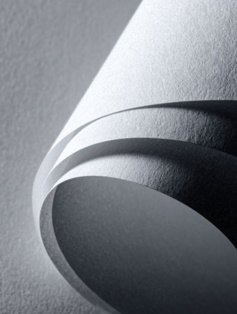 Textured layers of gray paper create a visually striking composition, emphasizing curves and shadows in a minimalistic artistic arrangement.の素材