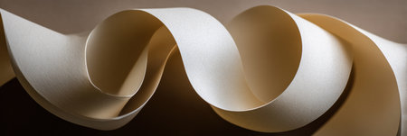 Light plays on undulating sheets of cream-colored paper, highlighting their smooth texture and graceful curves for a visually appealing effect.の素材
