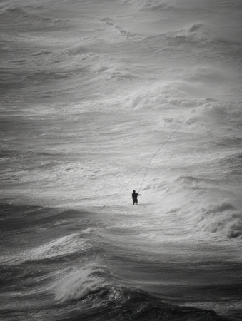 A lone fisherman battles strong waves while fishing in the turbulent ocean during sunset, showcasing resilience against natures elements.の素材