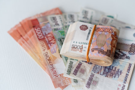 Various Russian Rubles are neatly displayed, highlighting a prominent stack of five thousand ruble...
