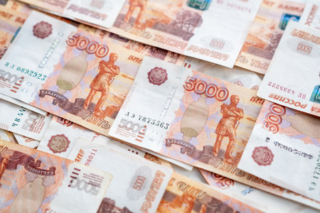 Various denomination banknotes of Russian currency are arranged neatly on a flat surface, showing...