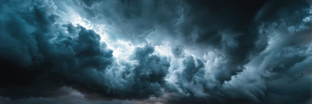 Dark storm clouds swirl dramatically in the evening sky, hinting at an impending storm while illuminating the horizon with a mystical glow.の素材