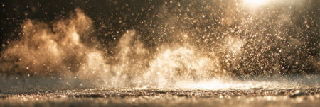 Droplets of rain hit the ground, creating a misty atmosphere as the sun sets, casting a warm glow over the scenery in the evening light.の素材