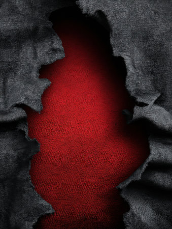 A piece of torn fabric exposes a bright red surface behind it, showing the contrast between the dark material and vibrant background in an artistic mannerの素材