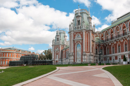 Visitors admire the stunning architecture of Tsaritsyno, a historical park featuring ornate structures and natural beauty under a blue sky.の写真素材