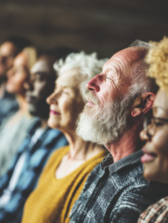A diverse group of men and women sit in a row, each appearing contemplative and engaged in a community event, showing a mix of age and ethnicity.の素材
