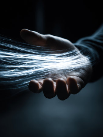 A hand grips strands of glowing energy in a dark environment, highlighting the interaction between humanity and technology. The scene evokes a sense of wonder.の素材