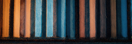 Vertical stripes of varying colors create an abstract pattern on the surface, showing a blend of tones and textures that evoke a playful atmosphere.の素材