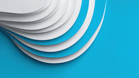 White paper layers are carefully stacked against a bright blue backdrop, showing a minimalist design with clean lines and subtle shadows.の素材