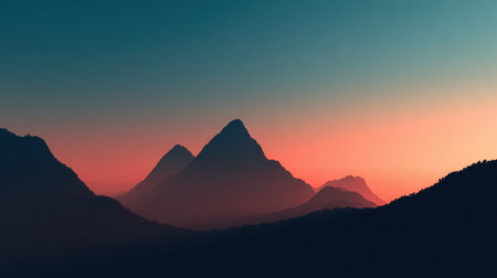 Dramatic mountain peaks rise against a vibrant sunset sky, casting shadows and creating a peaceful scene that captures the beauty of nature in twilight.の素材