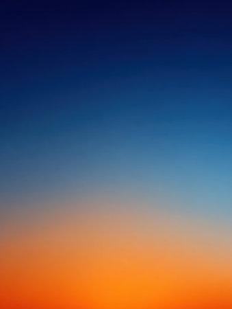 A stunning sky displays a gradient of colors as the sun sets, blending deep blue at the top with warm orange near the horizon, creating a peaceful atmosphere.の素材