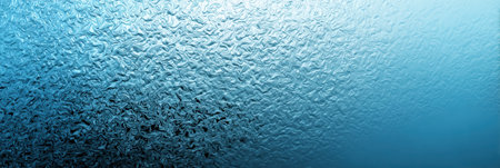 Delicate waves of water create an artistic display on a textured surface, showcasing a range of blue tones in a serene environment, inviting reflection.の素材